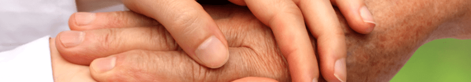 Two hands clasped together in a comforting gesture.